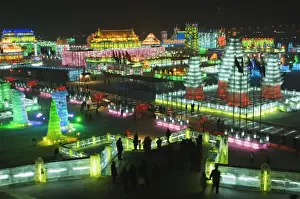 Snow and ice sculptures illuminated at night at the Ice Lantern Festival