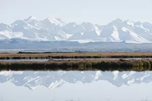 Snow mountains reflected in a lake, Bayanbulak, Xinjiang Province, China, Asia