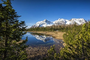 Snowy Prints: Snowy Corno Di Braccia is reflected in Lake Entova, Province of Sondrio, Malenco Valley