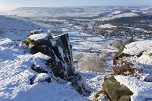 Peak District Prints: Snowy Curbar village beyond the rocks of Curbar Edge