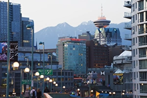 Snowy mountains behind downtown buildings and Harbour Centre Tower, Vancouver Snowy mountains behind downtown buildings and Harbour Centre Tower, Vancouver