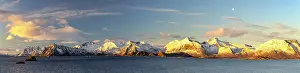 Fjord Prints: Snowy mountains rise above the sea under a clear sky in Vestvagoy Island