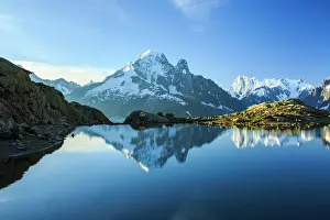 Mountain Peak Prints: The snowy peaks of Mont Blanc are reflected in the blue water of Lac Blanc at dawn