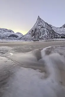 Motion Blur Prints: Snowy peaks and sandy beach framed by the icy waves of frozen sea at dawn, Ersfjord