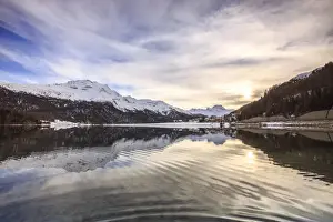 Maloja Prints: Snowy peaks and woods are reflected in Lake Silvaplana at sunset
