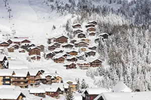 Snowy woods frame the typical alpine village and ski resort, Bettmeralp, district of Raron