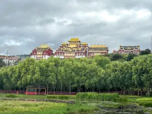 Wetlands Prints: Songzanlin Monastery stands tall over wetland with clouds in Shangri-La City