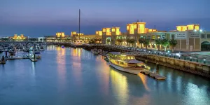 Shopping Mall Prints: Souk Shark Mall and Kuwait harbour, illuminated at dusk, Kuwait City, Kuwait, Middle East