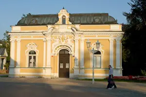 Spa building dating from the 19th century and promenading couple in the spa town of Frantiskovy Lazne, Karlovarsky Region, West Bohemia, Czech