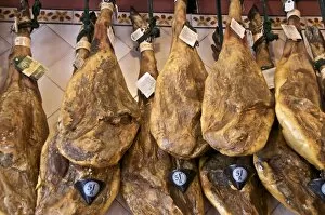 Images Dated 9th April 2010: Spanish hams hanging in a restaurant bodega, Seville, Andalusia, Spain, Europe