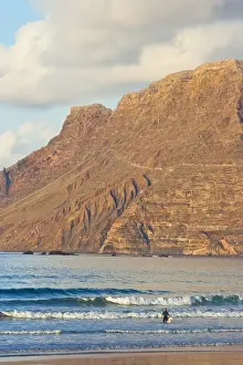 Sea Cliffs Prints: Spectacular 600m volcanic cliffs of the Risco de Famara rising over Lanzarotes finest surf beach at Famara in the north