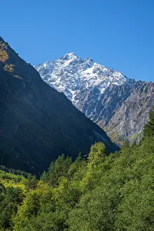 Trails Prints: Spectacular mountains rise above lush valleys under clear blue sky in North Ossetia
