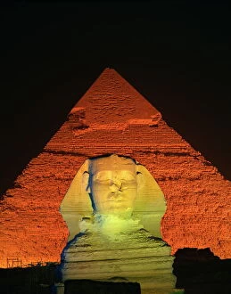 The Sphinx and one of the pyramids illuminated at night, Giza, UNESCO World Heritage Site