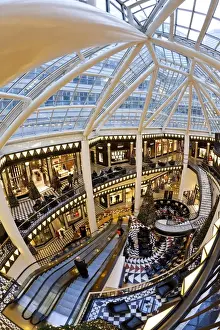 Shopping Mall Prints: Spiral staircase and decorative floor tiles in luxury shopping centre