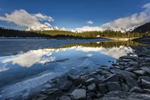 Valtellina Prints: The spring thaw melts ice while snowy peaks are reflected in Lake Palu, Malenco Valley