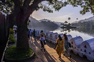 Kids Prints: Sri Lankan people walking at Kandy Lake at sunrise