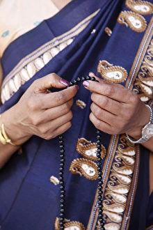 Beads Prints: Sri Lankan woman with Buddhist prayer beads, Paris, France, Europe