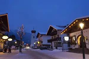 Tyrol Prints: St. Anton am Arlberg main road and church in winter snow in the evening