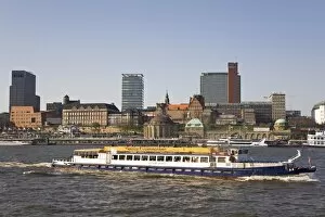 Images Dated 17th April 2010: The St. Pauli skyline is seen behind a ship giving a guided tour of the port of Hamburg