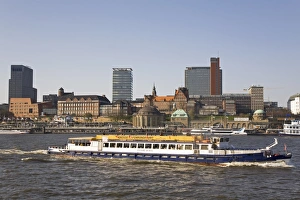 Images Dated 17th April 2010: The St. Pauli skyline is seen behind a ship giving a guided tour of the port of Hamburg