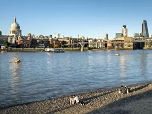 Millennium Bridge Collection: St. Pauls and City skyline, beach beside the River Thames, London, England, United Kingdom