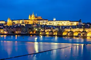 Light Beam Prints: St. Vitus Cathedral and Prague Castle lit up during the evening blue hour reflecting
