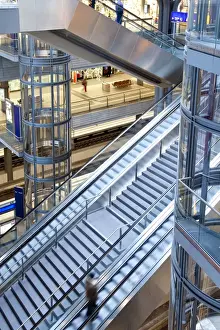 Railway Stations Prints: Staircase and escalators leading to the platform in modern train station