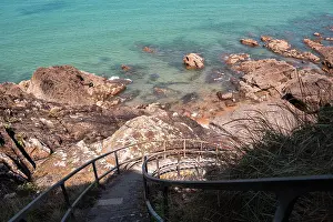 Footpath Prints: Stairway leads down to clear waters and rocks on the coast in Brittany near Saint-Malo