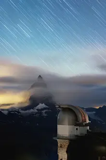 Starscape Prints: Star trail in the night sky on Matterhorn from observatory tower of Kulmhotel Gornergrat