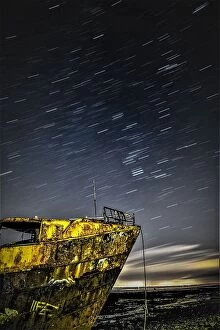 : Star trails above the derelict trawler Vita Nova, from the Cumbrian Coast, Furness Peninsula