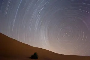 Erg Chebbi Prints: Star trails in night sky around Polaris (the pole star) over dunes of the Erg Chebbi