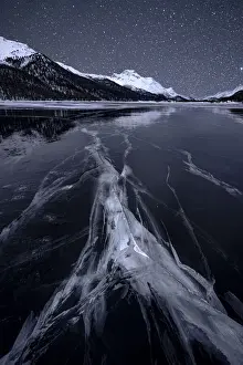 Engadine Prints: Starry night sky over the cracked ice on frozen Lake Silvaplana in winter, Maloja