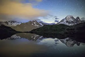 Chamonix Prints: The stars illuminate the snowy peaks and reflected in Lac de Cheserys