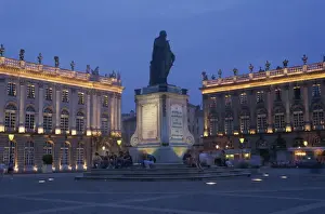 Nancy Prints: Statue and buildings illuminated at night in the Place Stanislas in Nancy