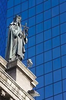 Statue on the Cathedral Metropolitana and modern office building in Plaza de Armas