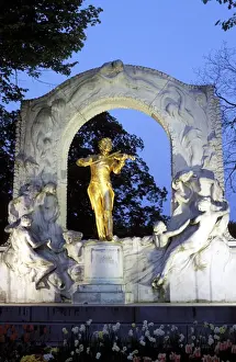 Statue of the composer Johann Strauss on the Strauss memorial at twilight