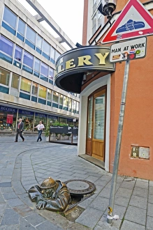 Humor Prints: Statue of Cumil, the man at work in a hole, Bratislava, Slovakia, Europe