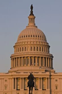 Statue in front of the dome of the U.S. Capitol Building, evening light, Washington D