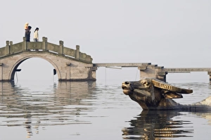 Images Dated 7th January 2008: Statue of a golden water buffalo in the waters of West Lake, Hangzhou, Zhejiang Province