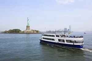 The Statue of Liberty and ferry, Liberty Island, New York City, New York