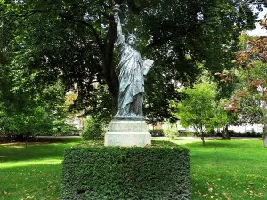 Enjoyment Prints: Statue of Liberty stands in the Jardin du Luxembourg surrounded by trees and greenery in Paris during daytime