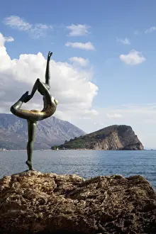 Budva Prints: Statue of naked dancing girl on a rock near the Adriatic with Sveti Nikola island in the background