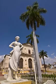 Statue in front of the Plaza Mayor with Iglesia Parroquial de la Santisima Trinidad