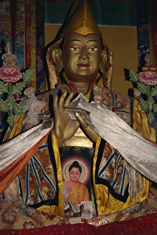 Offerings Prints: Statue with scarves and offerings of money in Ganden monastery, Tibet, China, Asia