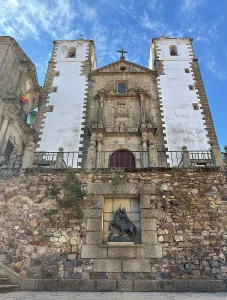 Center Prints: Statue of St George with Church of San Francisco Javier in Caceres, Spain, under clear sky