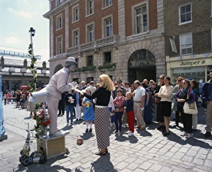 Costume Prints: Statue street performer, and group of people watching, Covent Garden, London
