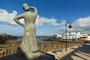 Old Harbour Prints: Statue of woman looking out to sea by the old harbour at this north west coast village