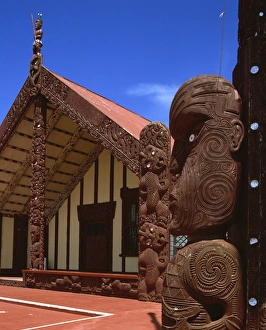 Meeting Houses Prints: Statues and carvings of tikis on a Marai, Maori Meeting House, at Rotorua