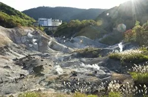 Images Dated 3rd October 2009: Steam vents in Jigokudani geothermal area, hotels of Noboribetsu Onsen beyond