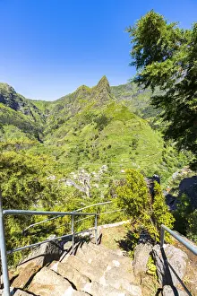 Steep steps on mountain path to the green alpine valley and village of Serra de Agua